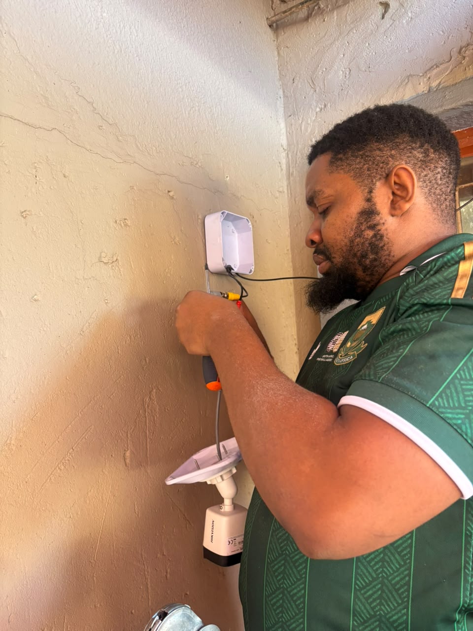 Technician installing a CCTV security camera
